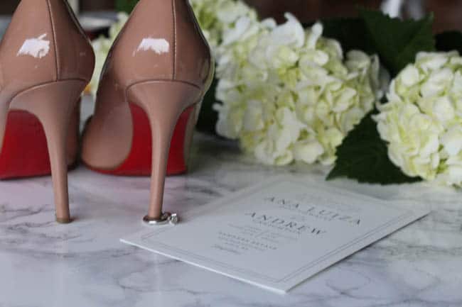 wedding invitations and bride's shoes